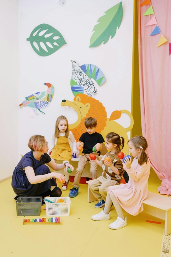 Colorful preschool classroom with teacher and children engaging in activities with toys.